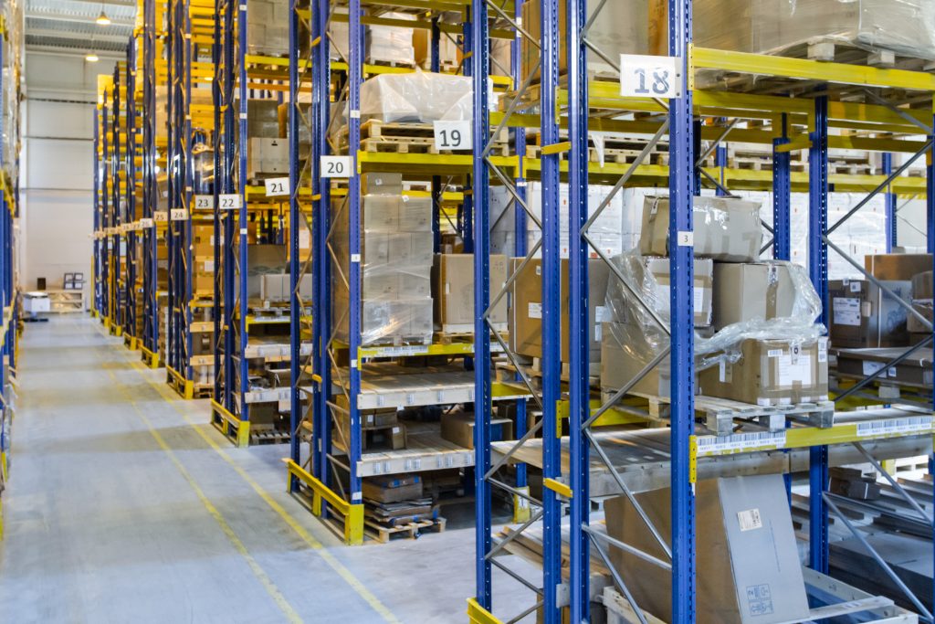 Interior of a modern warehouse storage with rows and goods boxes on high shelves